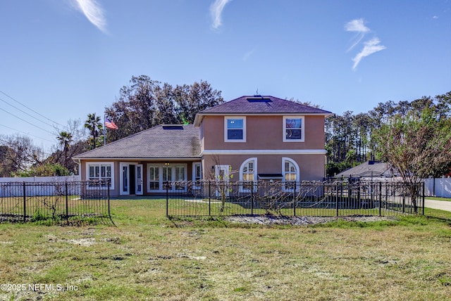 rear view of property with french doors and a yard