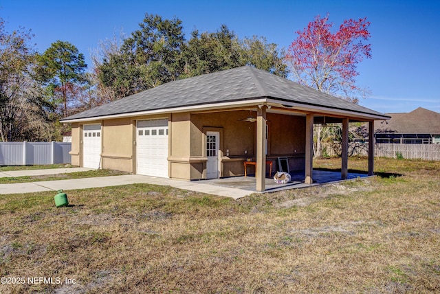 exterior space with a garage and a lawn