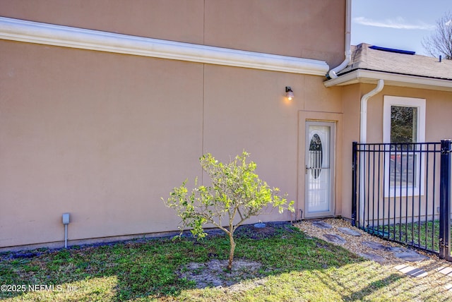 entrance to property with a lawn