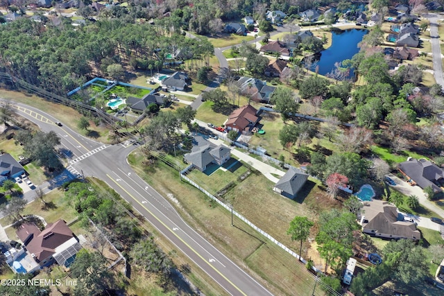 birds eye view of property with a water view