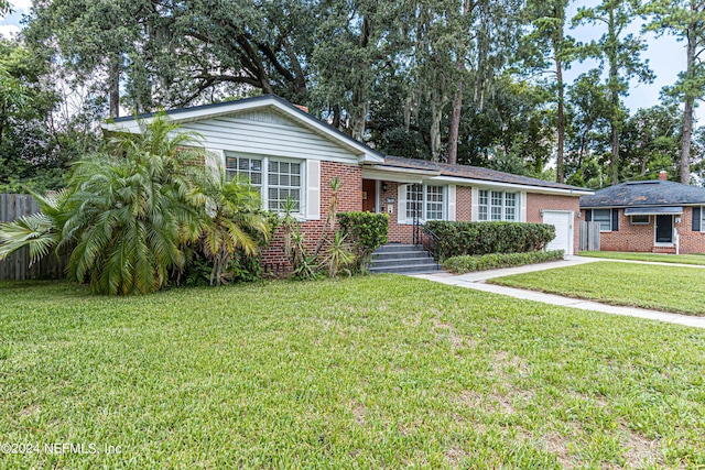 ranch-style home featuring a garage and a front yard