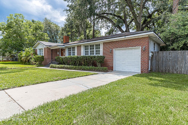 ranch-style house featuring a garage and a front yard