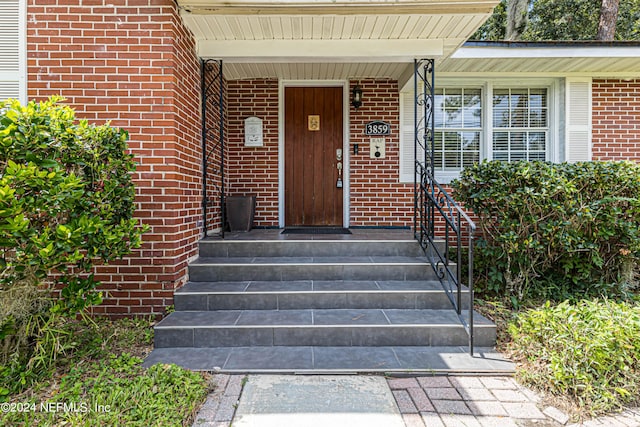 view of exterior entry featuring a porch