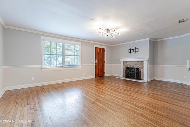 unfurnished living room with crown molding and light hardwood / wood-style floors