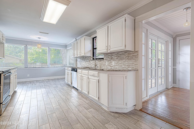 kitchen featuring stainless steel appliances, hanging light fixtures, and white cabinets