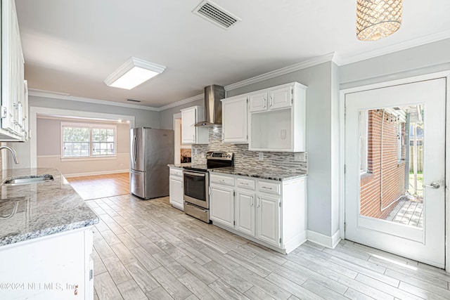 kitchen featuring stainless steel appliances, white cabinetry, sink, and wall chimney range hood