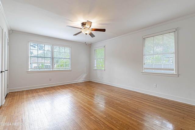 empty room with crown molding, ceiling fan, and hardwood / wood-style floors