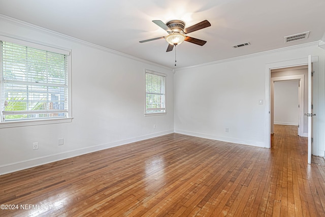 spare room with crown molding, ceiling fan, and hardwood / wood-style flooring