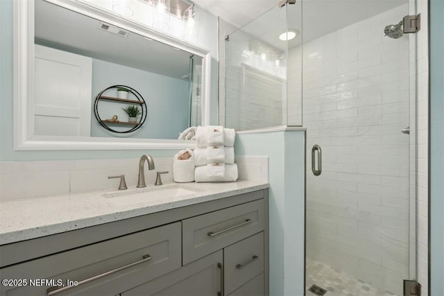 bathroom featuring vanity and an enclosed shower