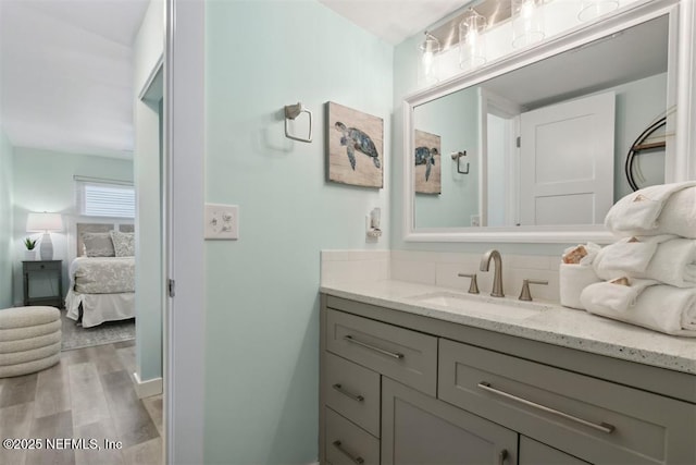 bathroom featuring hardwood / wood-style flooring and vanity