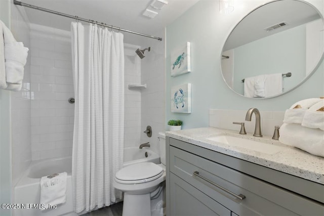 full bathroom with vanity, shower / bath combination with curtain, and toilet