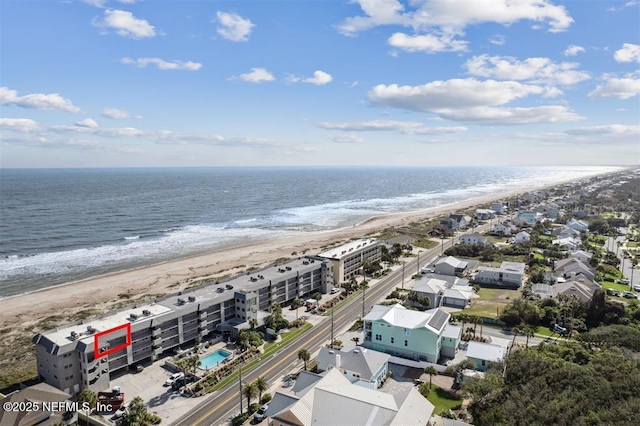 birds eye view of property featuring a water view and a view of the beach