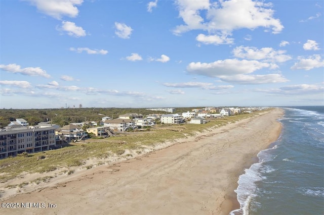 aerial view with a water view and a beach view