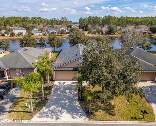 birds eye view of property with a water view