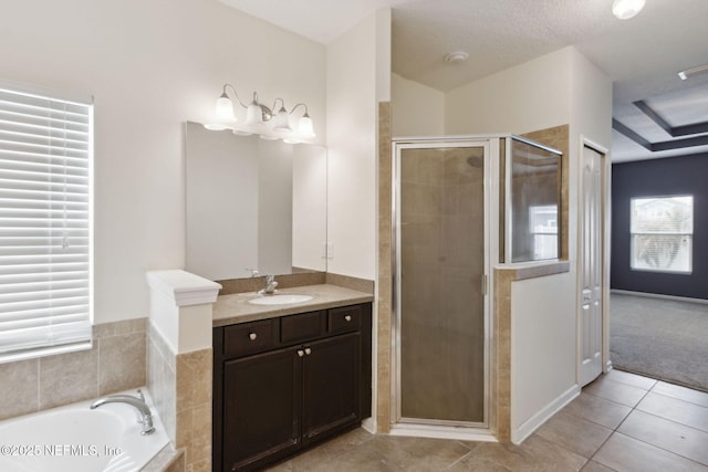 bathroom with tile patterned flooring, vanity, and separate shower and tub