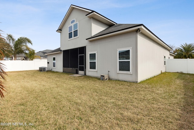 back of house with cooling unit and a yard