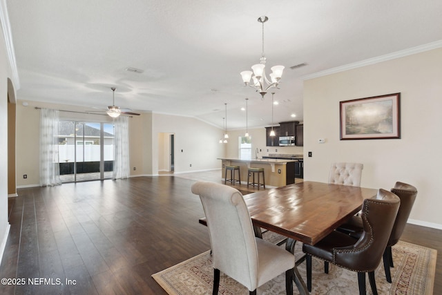 dining room with crown molding, vaulted ceiling, a healthy amount of sunlight, and ceiling fan with notable chandelier