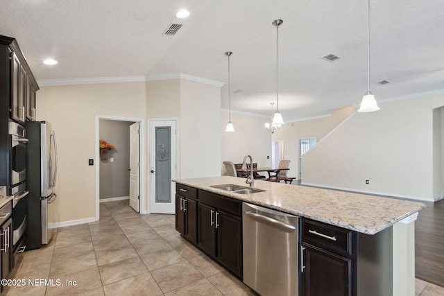 kitchen with sink, crown molding, decorative light fixtures, an island with sink, and stainless steel appliances