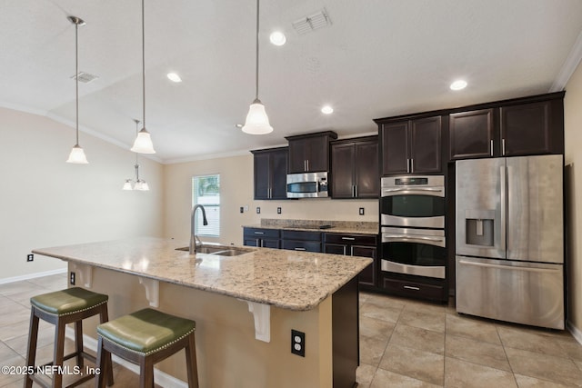 kitchen with hanging light fixtures, sink, an island with sink, and appliances with stainless steel finishes