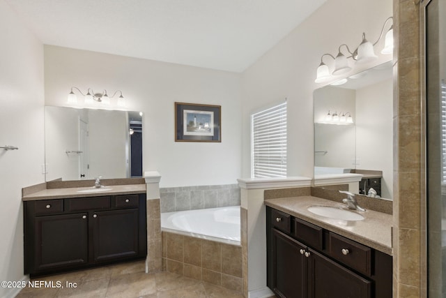 bathroom featuring vanity, tiled tub, and tile patterned flooring