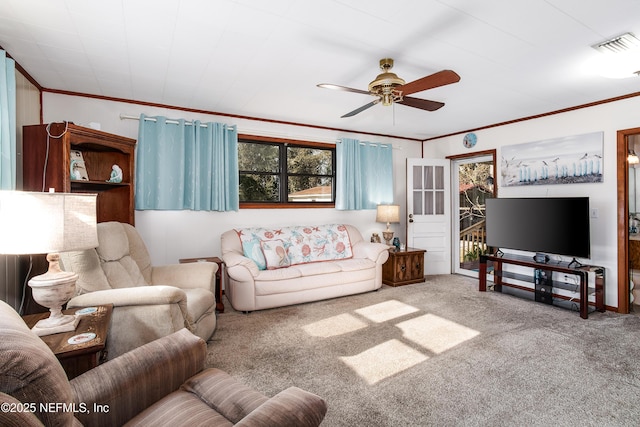 carpeted living room with ceiling fan and ornamental molding