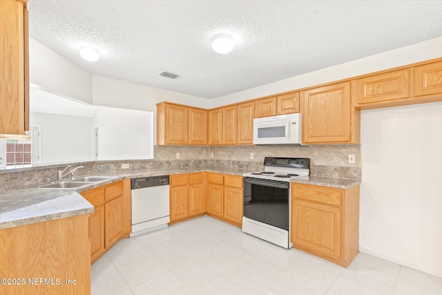 kitchen with sink, a textured ceiling, white appliances, and decorative backsplash