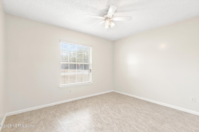 unfurnished room featuring ceiling fan and a textured ceiling