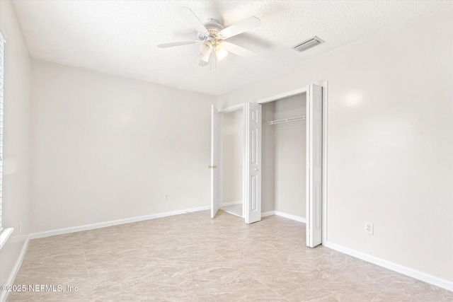 unfurnished bedroom featuring a textured ceiling, ceiling fan, and a closet