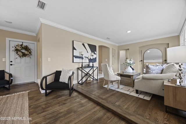 living room featuring dark hardwood / wood-style flooring and crown molding