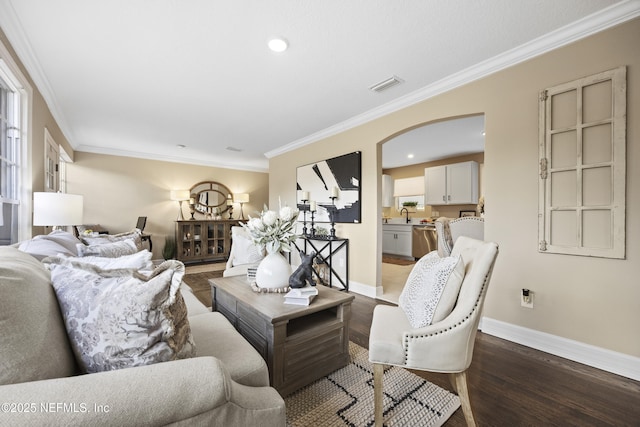 living room with crown molding, dark hardwood / wood-style floors, and sink