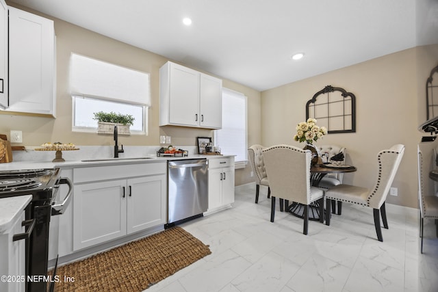 kitchen featuring white cabinetry, sink, and stainless steel dishwasher