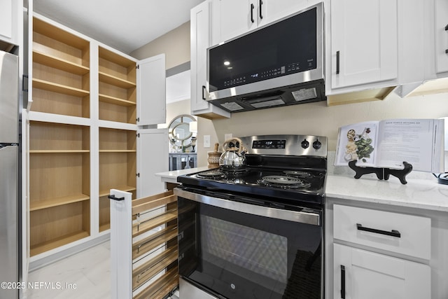 kitchen featuring light stone countertops, white cabinetry, and appliances with stainless steel finishes