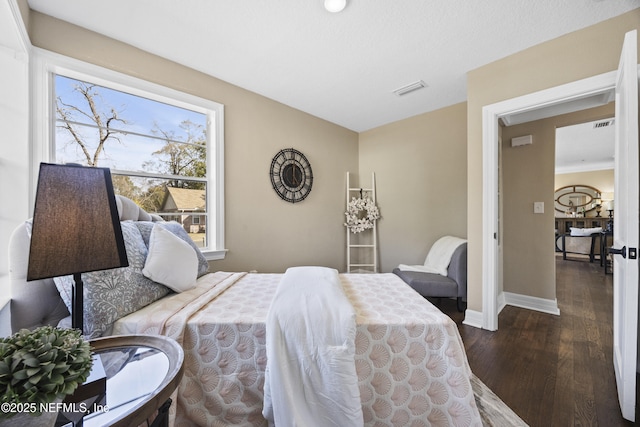 bedroom with dark wood-type flooring