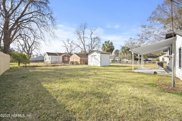 view of yard featuring a storage unit and a patio area