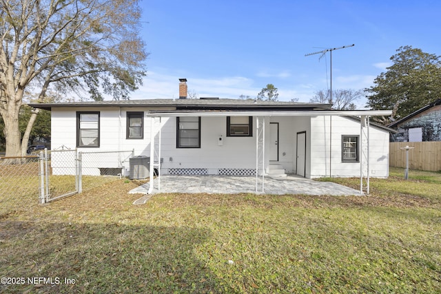 back of house with a patio, central AC, and a lawn