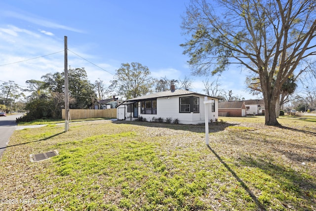 view of property exterior with a lawn