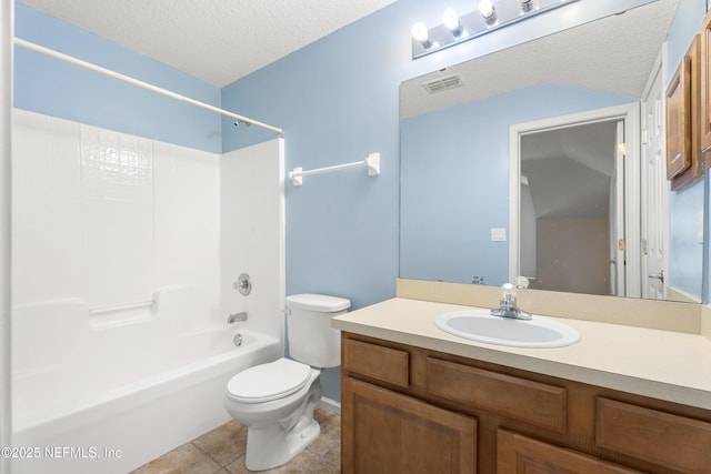 full bathroom with  shower combination, vanity, a textured ceiling, tile patterned floors, and toilet