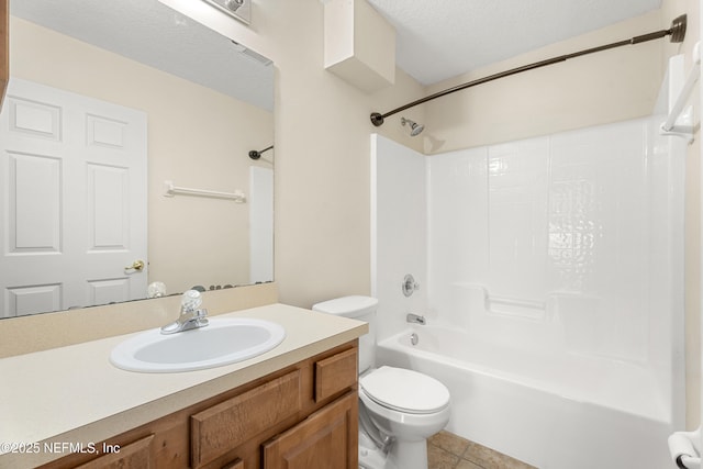 full bathroom featuring shower / bath combination, vanity, toilet, tile patterned floors, and a textured ceiling