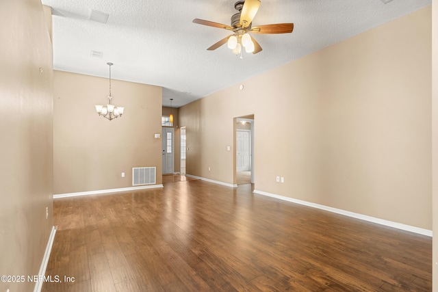 unfurnished room with dark hardwood / wood-style flooring, ceiling fan with notable chandelier, and a textured ceiling