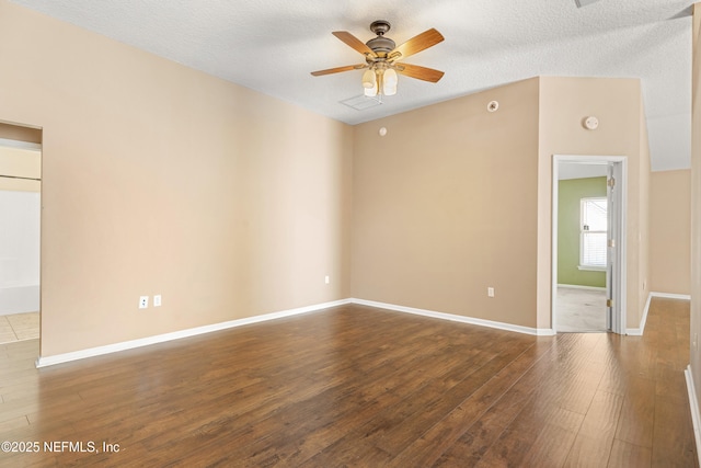 spare room with a textured ceiling, wood-type flooring, and ceiling fan