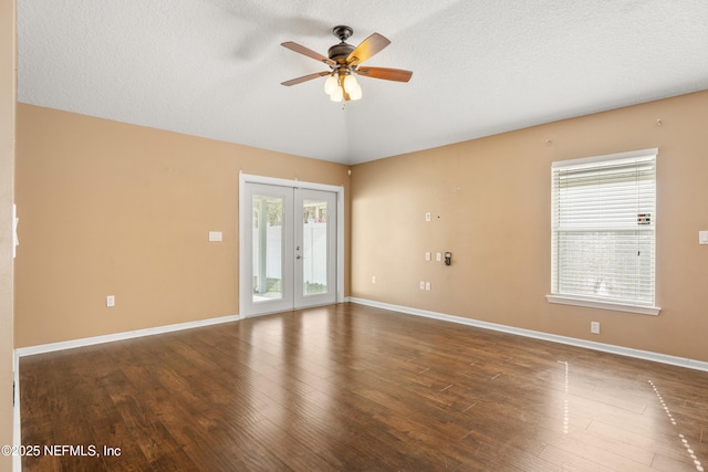 unfurnished room with french doors, ceiling fan, dark hardwood / wood-style floors, and a textured ceiling