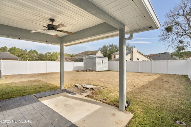 view of yard featuring a shed, a patio, ceiling fan, and central air condition unit