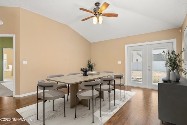 dining area featuring french doors, ceiling fan, dark hardwood / wood-style flooring, and vaulted ceiling