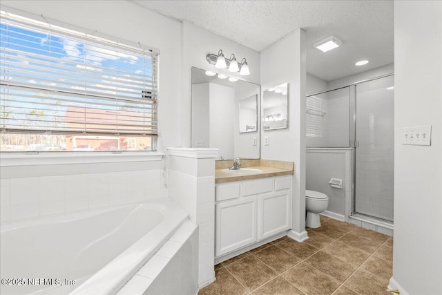 full bathroom featuring tile patterned floors, toilet, separate shower and tub, a textured ceiling, and vanity