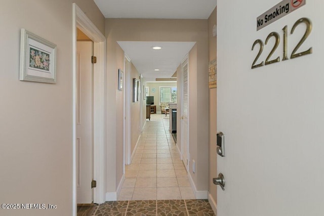 corridor with light tile patterned flooring