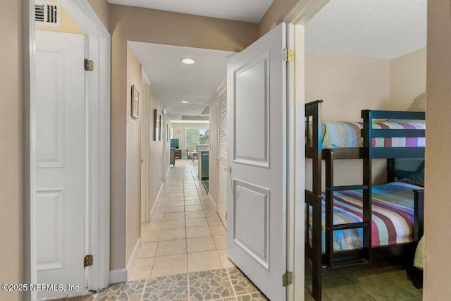 corridor featuring light tile patterned floors