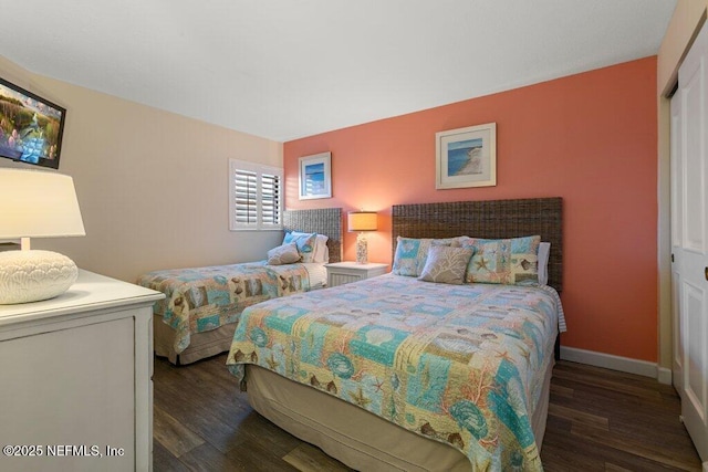 bedroom featuring dark hardwood / wood-style flooring and a closet