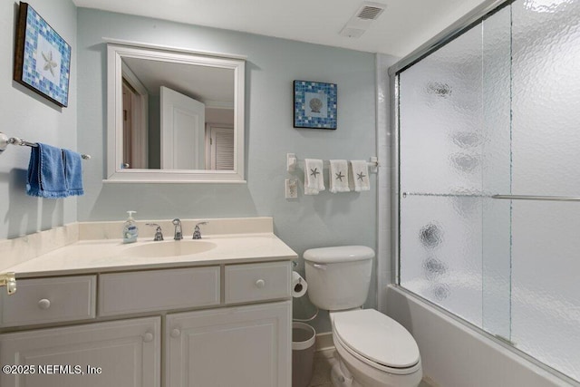 full bathroom with vanity, shower / bath combination with glass door, and toilet