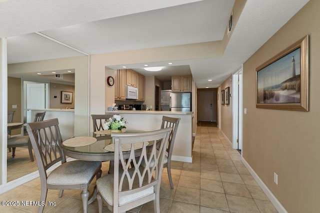 dining area featuring light tile patterned floors