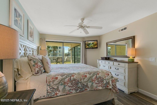 bedroom featuring dark hardwood / wood-style flooring, access to outside, and ceiling fan